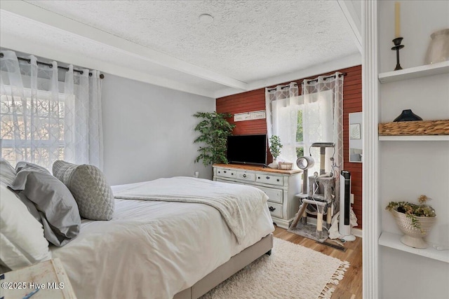 bedroom featuring a textured ceiling and light wood-type flooring