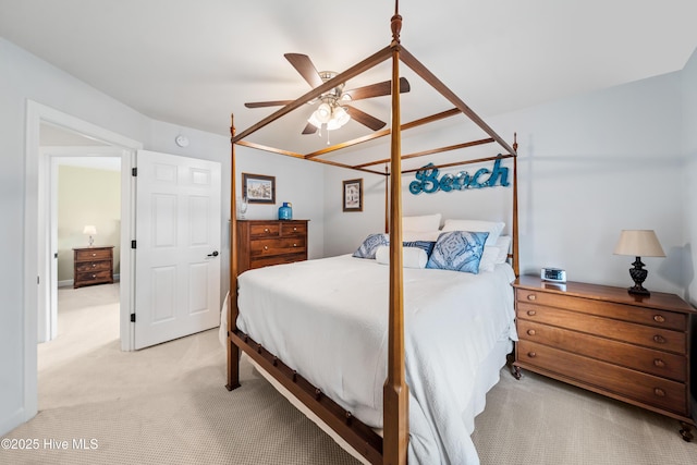 bedroom featuring light colored carpet and a ceiling fan