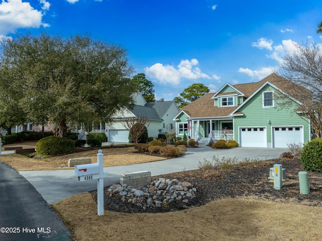 view of front of property featuring a garage, roof with shingles, a porch, and driveway