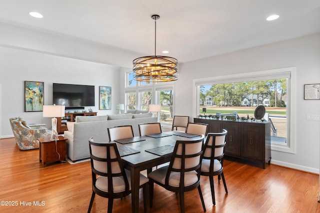 dining room featuring light wood finished floors, recessed lighting, baseboards, and an inviting chandelier