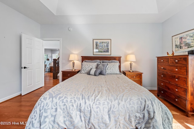 bedroom featuring baseboards and wood finished floors