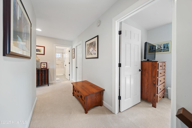 corridor featuring recessed lighting, light colored carpet, and baseboards