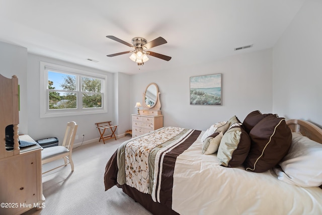 bedroom with visible vents, baseboards, light colored carpet, and ceiling fan