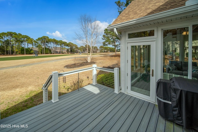 wooden terrace with a grill