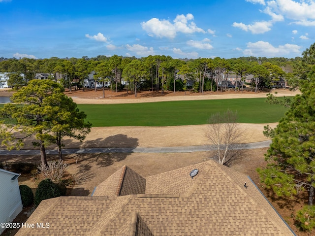 view of home's community with a yard