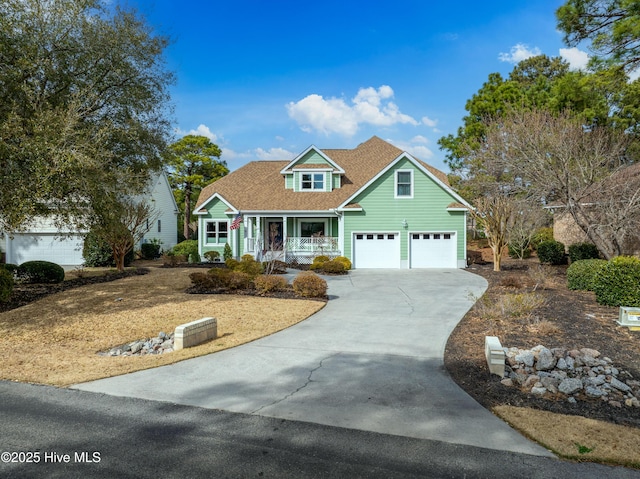 view of front of house with an attached garage, a porch, concrete driveway, and roof with shingles