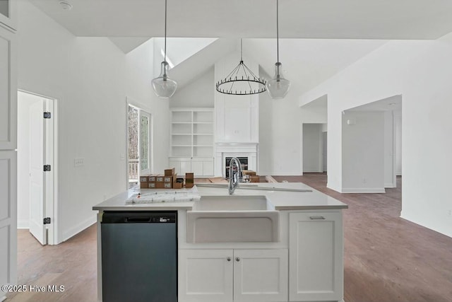 kitchen featuring dishwashing machine, high vaulted ceiling, a sink, open floor plan, and light countertops