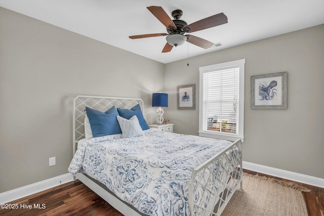 bedroom featuring ceiling fan, baseboards, and dark wood-style flooring