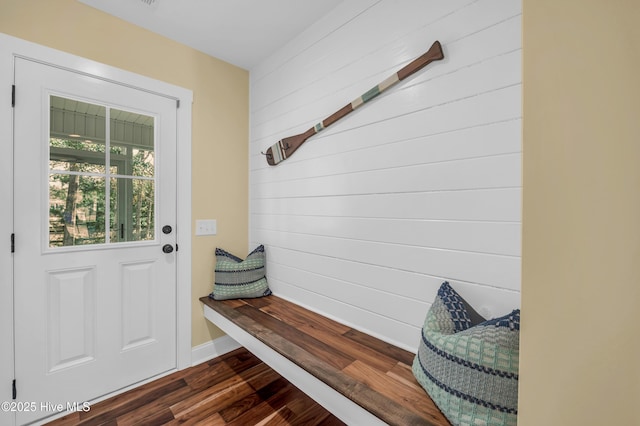 mudroom with wood walls, baseboards, and dark wood-style flooring