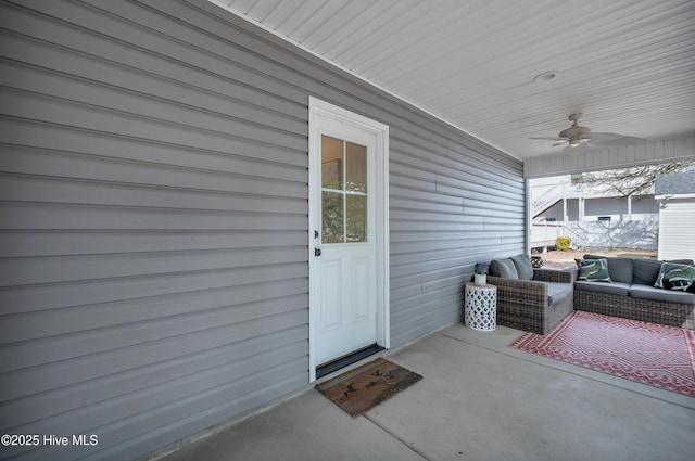 entrance to property featuring ceiling fan and an outdoor living space