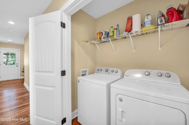 washroom featuring recessed lighting, washing machine and dryer, wood finished floors, laundry area, and baseboards