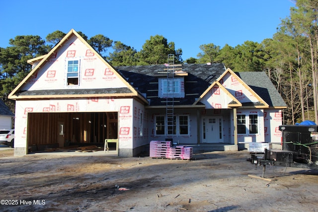 property under construction featuring a garage and a shingled roof