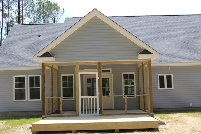 104 Backfield Dr, Newport, NC 28570 - rear view of house featuring roof with shingles and a sunroom