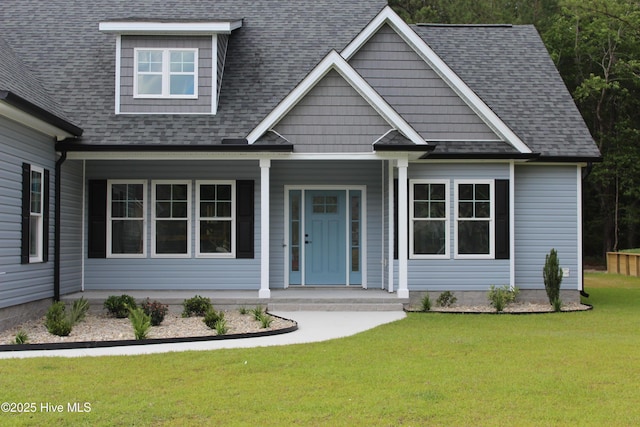 104 Backfield Dr, Newport, NC 28570 - view of front facade featuring covered porch, a shingled roof, and a front lawn