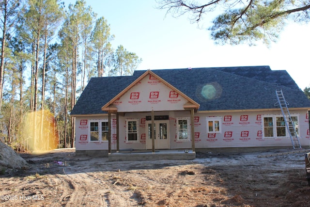 property in mid-construction with french doors and roof with shingles