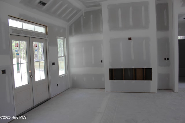 entryway featuring lofted ceiling and french doors