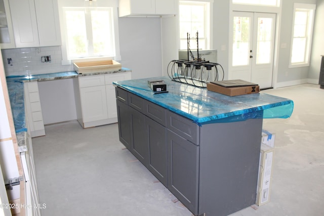 104 Backfield Dr, Newport, NC 28570 - kitchen featuring white cabinetry, light stone countertops, decorative backsplash, and healthy amount of natural light