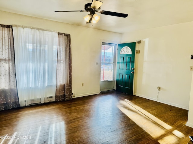 foyer featuring dark wood-style floors, ceiling fan, and baseboards