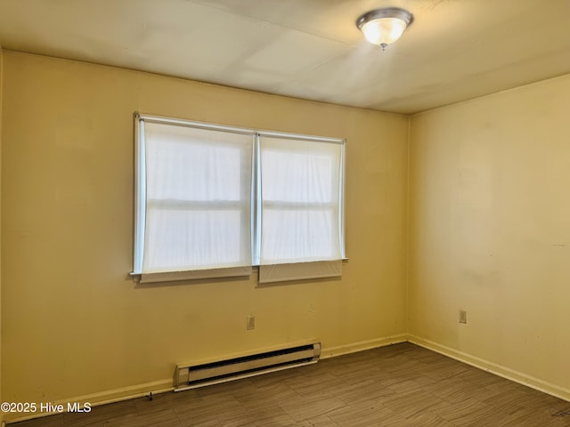 empty room with baseboards and a baseboard heating unit