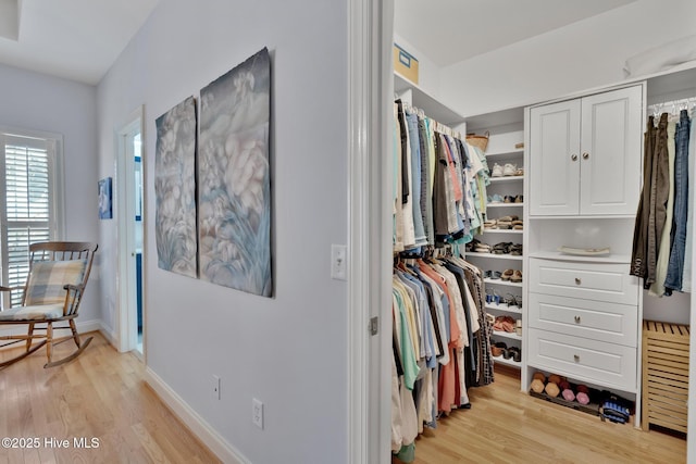 walk in closet with light wood-type flooring