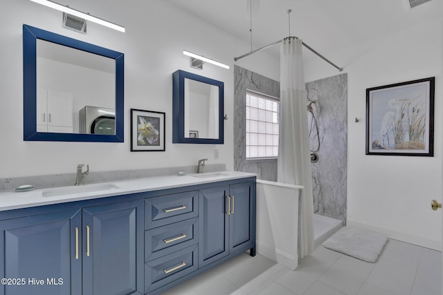 bathroom with baseboards, a sink, a shower with shower curtain, and double vanity