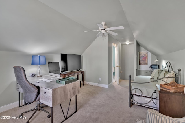 home office featuring light carpet, ceiling fan, vaulted ceiling, and baseboards