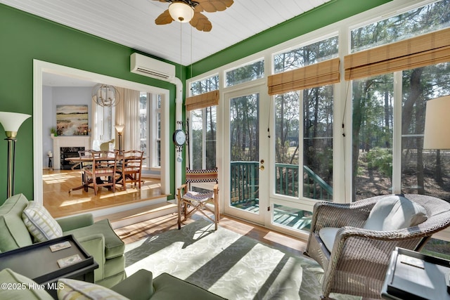 sunroom / solarium with a wall mounted AC and a ceiling fan