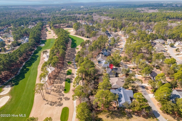 drone / aerial view featuring view of golf course and a residential view