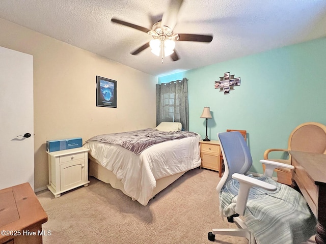 bedroom with a textured ceiling, ceiling fan, and light colored carpet