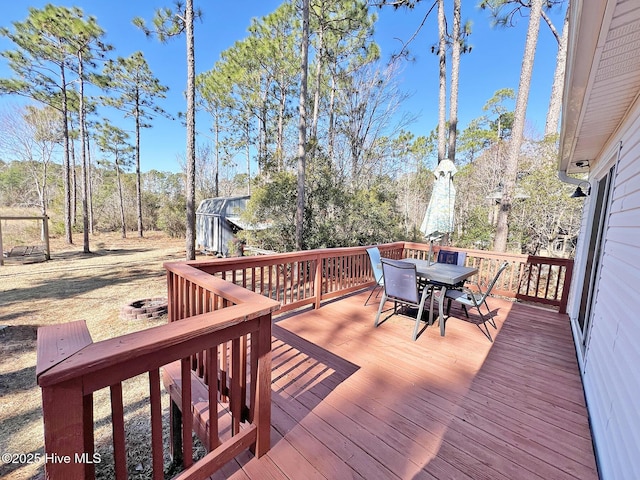 wooden terrace featuring outdoor dining space