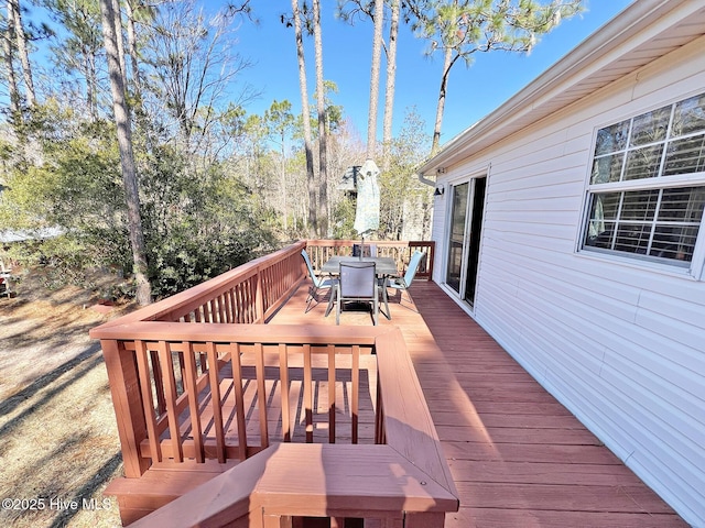 wooden deck featuring outdoor dining area