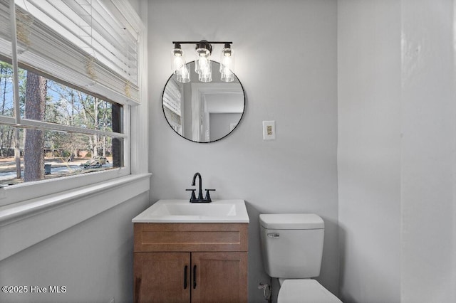 half bath featuring toilet and vanity