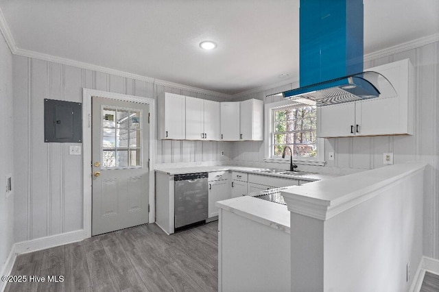 kitchen with island range hood, a sink, white cabinetry, stainless steel dishwasher, and electric panel