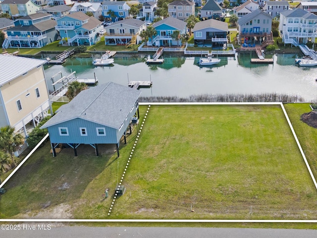 birds eye view of property featuring a water view and a residential view