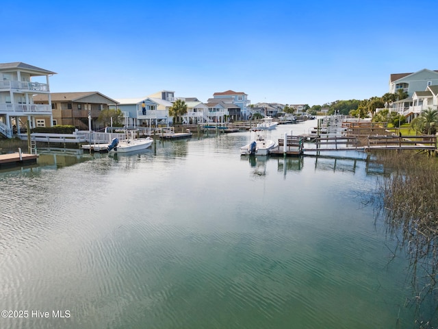 view of water feature featuring a dock and a residential view