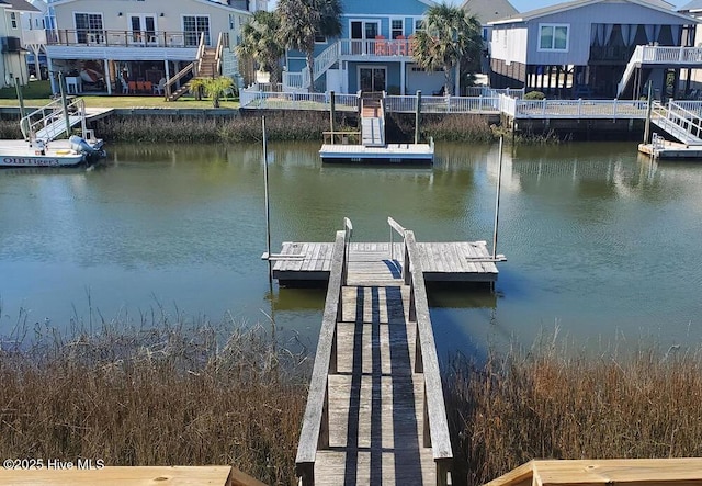 dock area featuring a water view and a residential view