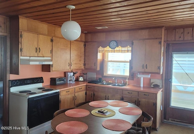 kitchen featuring electric range, hanging light fixtures, light countertops, under cabinet range hood, and a sink