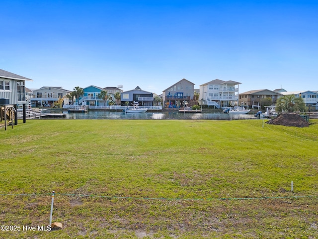 view of yard with a water view and a residential view