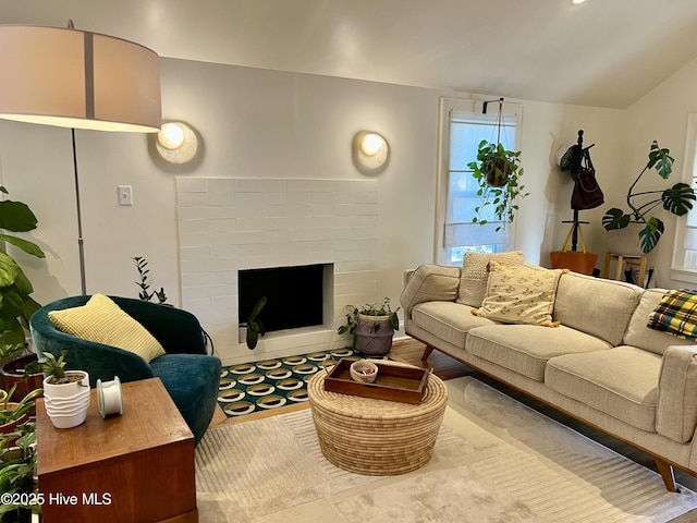 living room with lofted ceiling and a fireplace