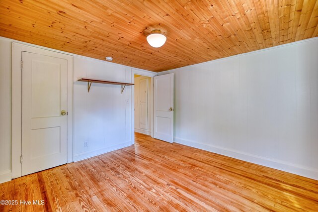 2121 Gibson Ave, Wilmington, NC 28403 - unfurnished bedroom featuring wood ceiling, light wood-style flooring, a closet, and baseboards