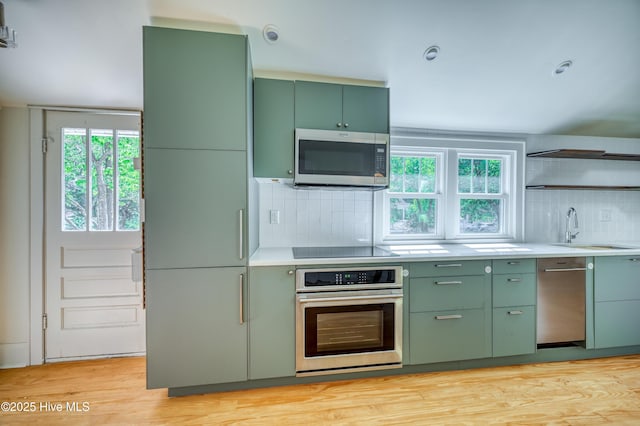 2121 Gibson Ave, Wilmington, NC 28403 - kitchen with green cabinets, stainless steel appliances, a sink, and healthy amount of natural light