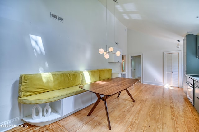 2121 Gibson Ave, Wilmington, NC 28403 - living area with high vaulted ceiling, light wood finished floors, and baseboards