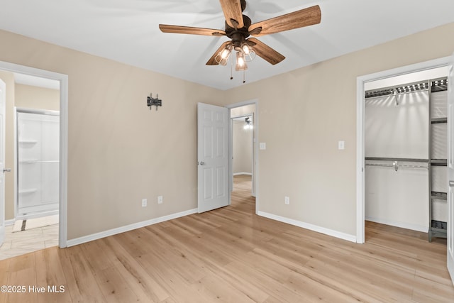 unfurnished bedroom featuring baseboards, a closet, and light wood-type flooring