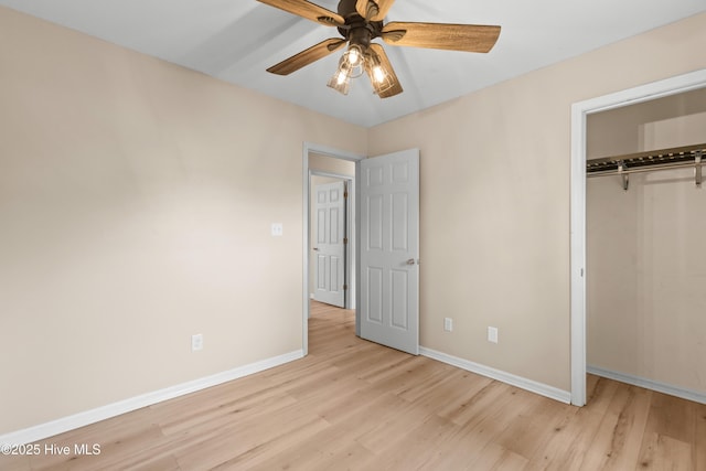 unfurnished bedroom with a closet, baseboards, ceiling fan, and light wood finished floors