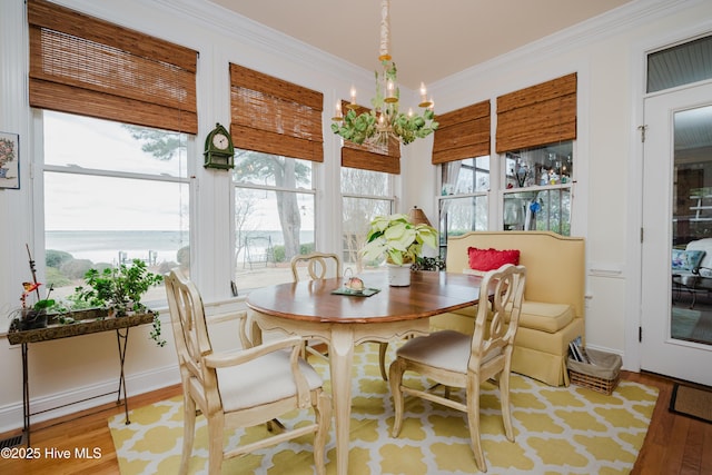 sunroom / solarium featuring an inviting chandelier