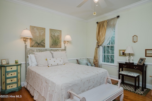 bedroom featuring ornamental molding, wood finished floors, and baseboards