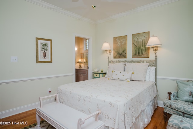 bedroom featuring ensuite bathroom, ornamental molding, wood finished floors, and baseboards