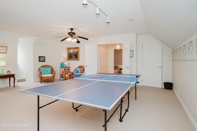 game room with lofted ceiling, a ceiling fan, track lighting, and light colored carpet