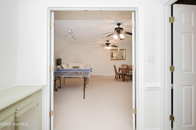 game room featuring a ceiling fan, light colored carpet, and vaulted ceiling