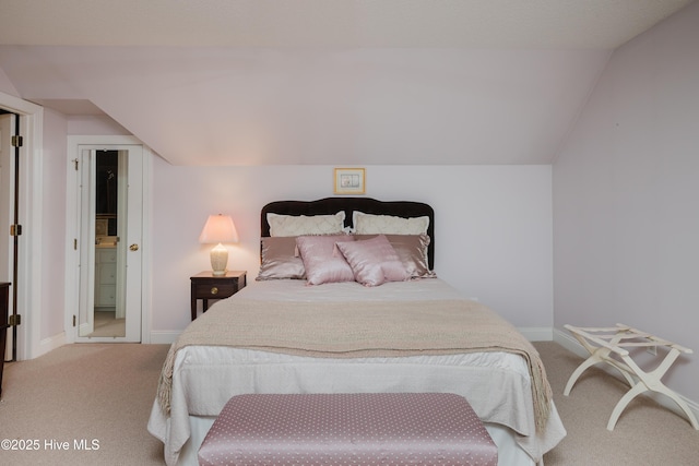 carpeted bedroom with lofted ceiling and baseboards